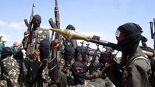 FILE - Armed al-Shabab fighters ride on pickup trucks as they prepare to travel into the city, just outside the capital Mogadishu, in Somalia on Dec. 8, 2008. 