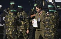 Israeli Ofer Kalderon who has been held hostage by Hamas in Gaza since October 7, 2023, walks next to Hamas fighters before being handed over to the Red Cross