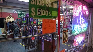 A customer sits for a shoe shine at a shoe repair shop on Feb. 3, 2023, in New York