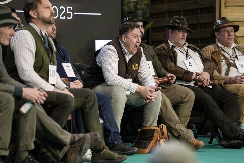 The later winner Fabian Menzel, center, exercises as he waits to perform to imitate a stag in heat during the German Championship of Deer-Calling