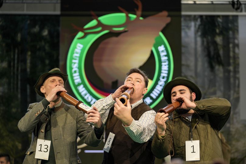 Winner Fabian Menzel, center, 2nd placed Thomas Soltwedel, left, and 3rd placed Jerome Boehm perform to imitate a stag in heat at the German Championship of Deer-Calling