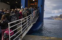 Passengers board a regularly scheduled ferry to Athens' port of Piraeus, after a spike in seismic activity raised concerns about a potentially powerful earthquake in Santorini