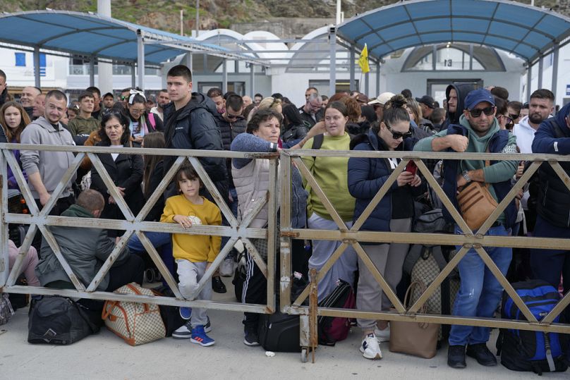 People wait for the arrival of a regularly scheduled ferry to Athens' port of Piraeus, after a spike in seismic activity raised concerns about a potentially powerful earthquak