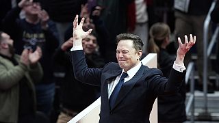 Elon Musk arrives on stage to speak at an indoor Presidential Inauguration parade event in Washington, Monday, Jan. 20, 2025. 