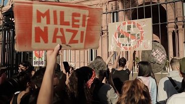 Demonstrators outside the Argentinian government hold up a ‘Milei Nazi’ banner