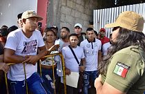 A Mexican migration officer explains to migrants that permission to travel across Mexico to the US-Mexico border was suspended.