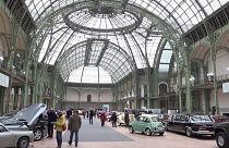 People looking at vintage cars on display at Grand Palais in Paris