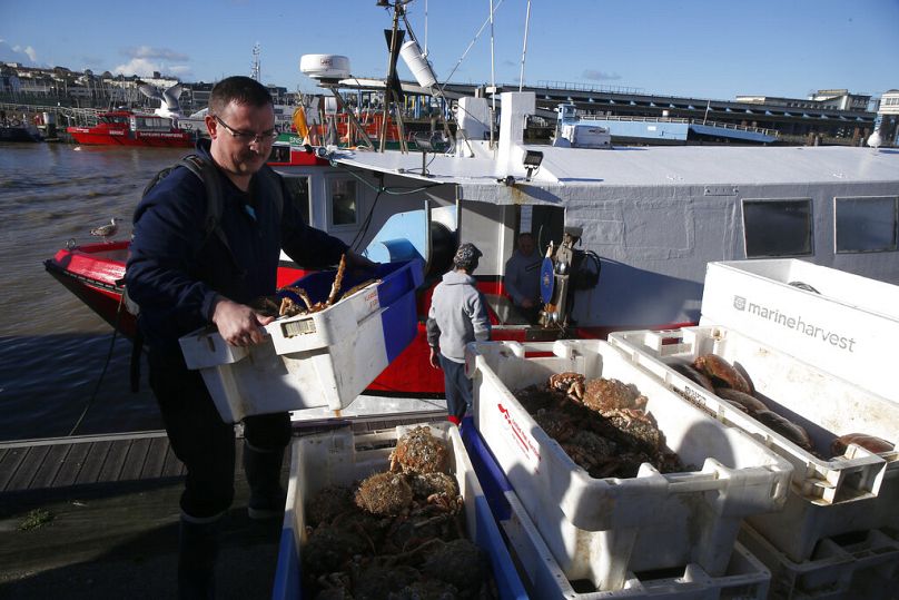 A French fisherman carries boxes of crabs in the port of Boulogne-sur-Mer, northern France.