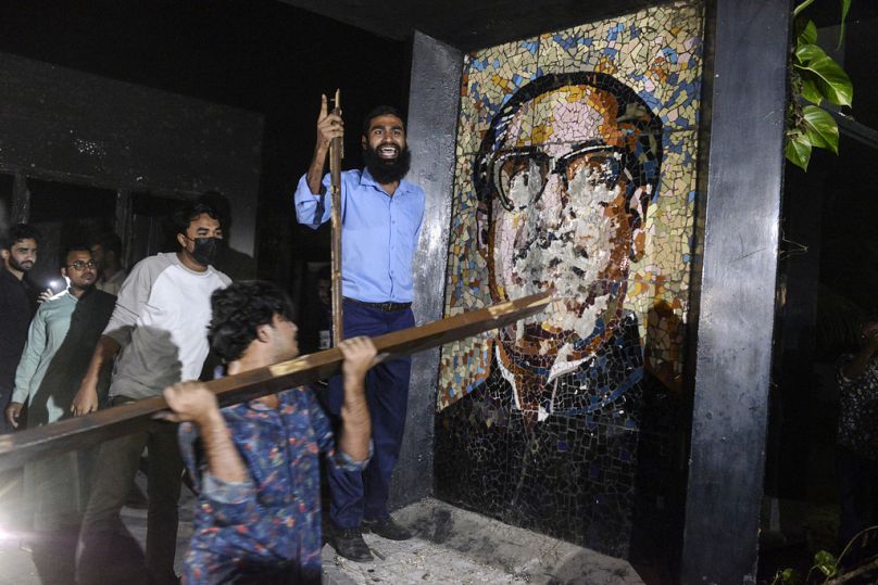 Protesters destroy a portrait of Sheikh Mujibur Rahman, Bangladesh's former leader and the father of the ousted PM Sheikh Hasina at his residence near Dhaka, February 2025