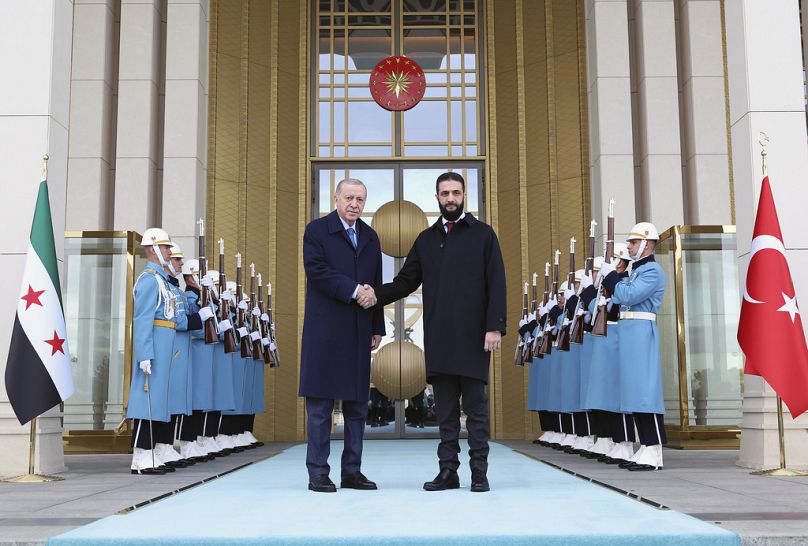 Turkish President Recep Tayyip Erdogan greets Syria's interim President Ahmad al-Sharaa ahead of meeting in presidential palace in Ankara, Turkey, Tuesday, Feb. 4, 2025. 