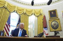 President Donald Trump speaks to reporters after signing executive orders in the Oval Office of the White House