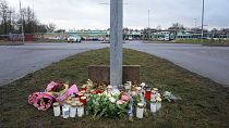 Flowers and candles are placed at a makeshift memorial near the scene of a shooting on the outskirts of Orebro, Sweden, Wednesday, Feb. 5, 2025. 