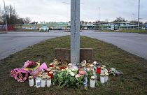 Flowers and candles are placed at a makeshift memorial near the scene of a shooting on the outskirts of Orebro, Sweden, Wednesday, Feb. 5, 2025. 