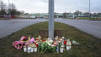 Flowers and candles are placed at a makeshift memorial near the scene of a shooting on the outskirts of Orebro, Sweden, Wednesday, Feb. 5, 2025. 