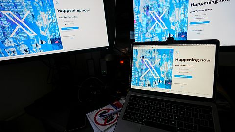 A view of a lap top and monitors showing the Twitter signing in page displaying the new logo, in Belgrade, Serbia, Monday, July 24, 2023