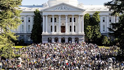 Several hundred demonstrators rally against President Donald Trump outside the California State Capitol on Wednesday, Feb. 5, 2025, in Sacramento, Calif.