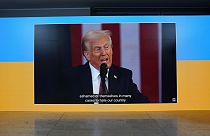 The inauguration speech of Donald Trump is shown on screens at the Ukraine house alongside the World Economic Forum in Davos, Switzerland, Monday, Jan. 20, 2025.