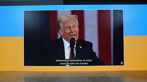 The inauguration speech of Donald Trump is shown on screens at the Ukraine house alongside the World Economic Forum in Davos, Switzerland, Monday, Jan. 20, 2025.