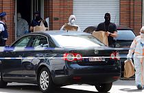 Police and forensic officers remove items during a house search in the Molenbeek district of Brussels on Wednesday, June 21, 2017. 
