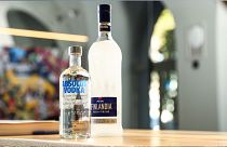 A bottle of Absolut vodka, along with a bottle of Finlandia vodka on a table. Pernod Ricard owns the Absolut brand.