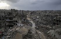 Palestinians walk in the destruction caused by the Israeli air and ground offensive in Jabaliya, Gaza Strip, Thursday, Feb. 6, 2025. 