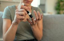 A woman checks her blood sugar levels.