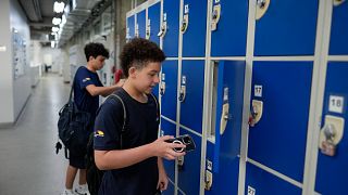 Students store their mobile phones in lockers as they head to class under a new law restricting their use on campus at Porto Seguro School in Sao Paulo, Thursday, Feb. 6, 2025