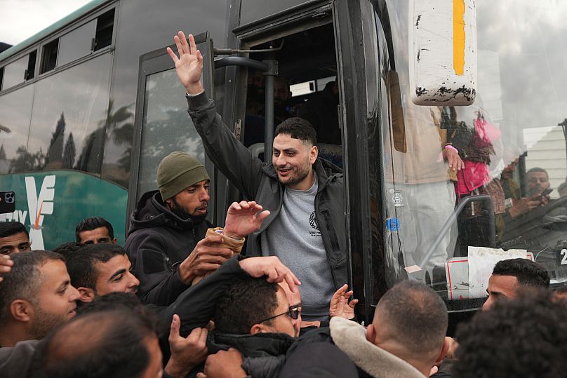 Freed Palestinian prisoners are greeted by a crowd as they arrive in the Gaza Strip after being released from an Israeli prison, 8 February, 2025