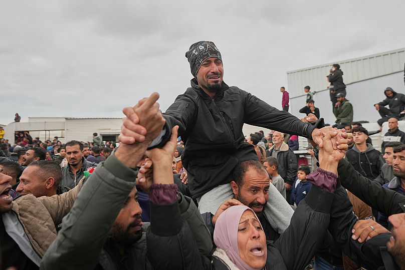 Freed Palestinian prisoners are greeted by a crowd as they arrive in the Gaza Strip after being released from an Israeli prison, 8 February, 2025