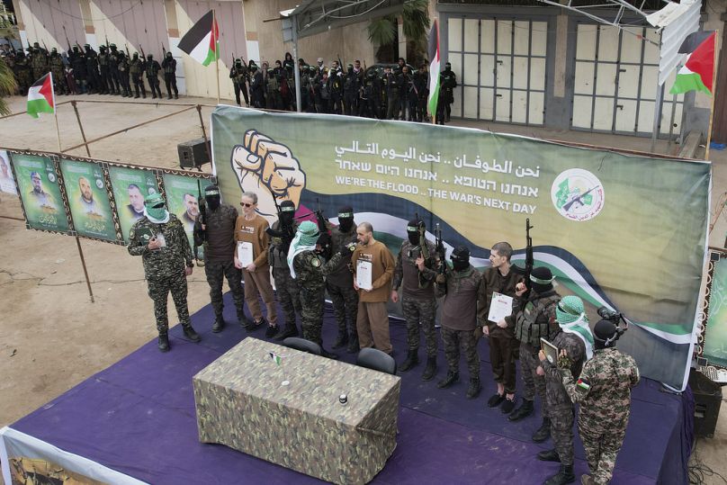 Eli Sharabi speaks on a microphone ahead of being handed over together with Ohad Ben Ami and Or Levy to the Red Cross by Hamas fighters in Deir al-Balah, Gaza, Feb. 8, 2025.