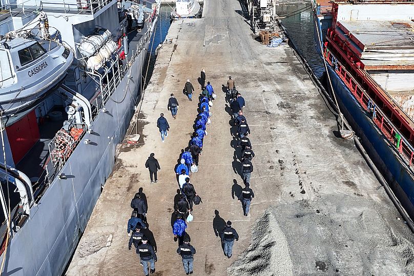 Des migrants escortés par la police italienne après avoir été rejetés par un tribunal, dans le port de Shengjin, au nord-ouest de l'Albanie, le mardi 28 janvier 2025.