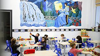 Kindergarten children play a classroom during a visit by local administration officials, on the opening day of schools and kindergartens in Bucharest, Romania, Monday, Feb. 8,