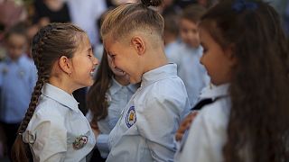 Children play before a ceremony marking the beginning of the school year at the Orizont Elementary School in Bucharest, Romania, Monday, Sept. 9, 2024.