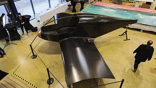 The Climate Impulse, a plane powered by liquid hydrogen, is displayed in a hangar in Les Sables d'Olonne, France.