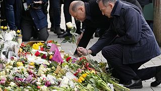 Chancellor Olaf Scholz, left, and Volker Wissing, Minister of Justice, lay down flowers at the site where a car crashed into a demonstration two days before, 15 February 2025.