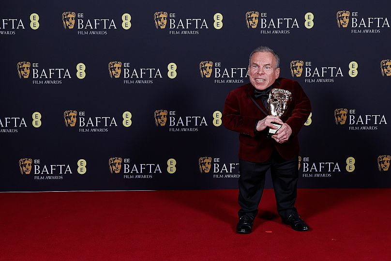 Warwick Davis poses with the BAFTA fellowship award at the 78th British Academy Film Awards, BAFTA's