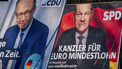 FILE - Election posters showing German Chancellor Olaf Scholz, right, and CDU top candidate for chancellor Friedrich Merz in Frankfurt, Germany, Feb. 8, 2025