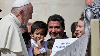 Pope Francis greets Swedish teenage environmental activist Greta Thunberg, right, during his weekly general audience in St. Peter's Square, at the Vatican in 2019.