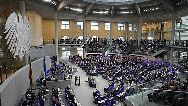 German opposition leader and Christian Union parties floor leader Friedrich Merz, center, speaks at a debate about migration at the German parliament Bundestag in Berlin