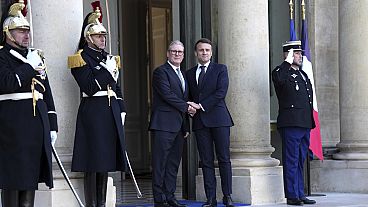 French President Emmanuel Macron greets Britain's Prime Minister Keir Starmer as he arrives for a meeting of leaders from key European Union nations in Paris