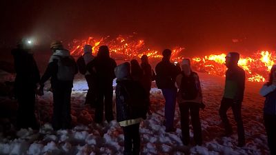 People close to lava flow Mount Etna, Feb 19, 2025