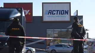 Police officers stand guard outside a shopping centre in Hradec Králové after two women were killed in a stabbing attack, 20 February, 2025