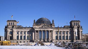 Snow covers the ground in front of the Reichstag building, home of the German parliament Bundestag in Berlin, Germany, Wednesday, Feb. 19, 2025.