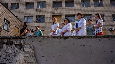 Medical workers stand by Okhmatdyt children's hospital in Kyiv, the site of the Russian missile attack in July 2024.