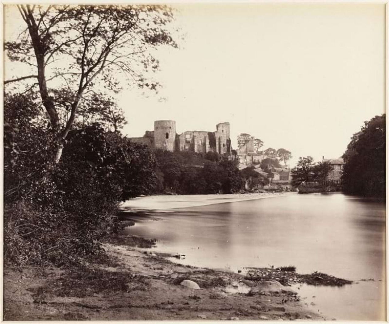 A view looking along the River Tees towards the ruins of Barnard Castle, County Durham. By James Mudd, 1860s