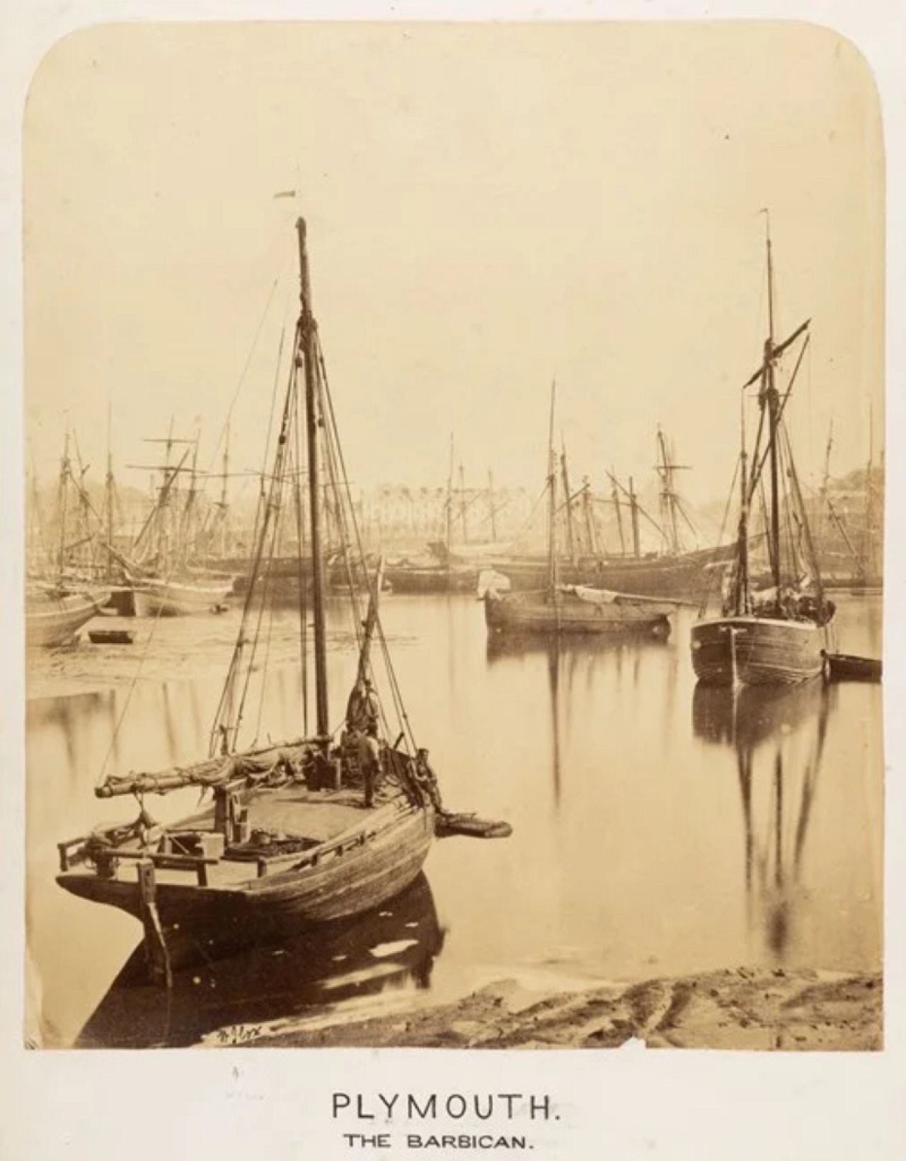 Fishing boats in the harbour at Plymouth, Devon, with the Barbican in the background. By W J Cox, 1860 to 1900.