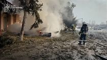 Firefighters extinguishing burning vehicle at site of airstrike. 21 February 2025 - Zolochiv, Kharkiv region, Ukraine