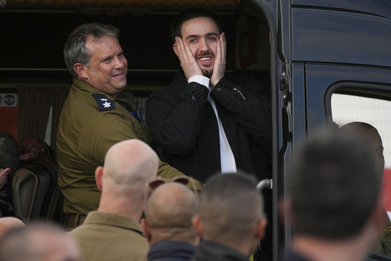 Freed Israeli hostage Omer Shem Tov gestures from a van as he arrives at Beilinson hospital in Petah Tikva, Israel, after he was released from Hamas captivity in the Gaza Stri