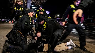 Police officers detain a man at the Holocaust memorial in Berlin after another man was seriously injured, 21 February, 2025