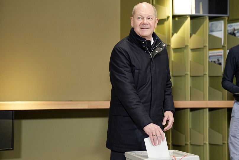 German Chancellor Olaf Scholz casts his vote at a polling station in Berlin, Germany, Sunday, Feb. 23, 2025